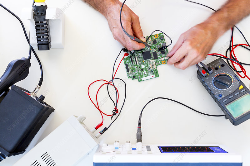 Person working in an electronics laboratory.